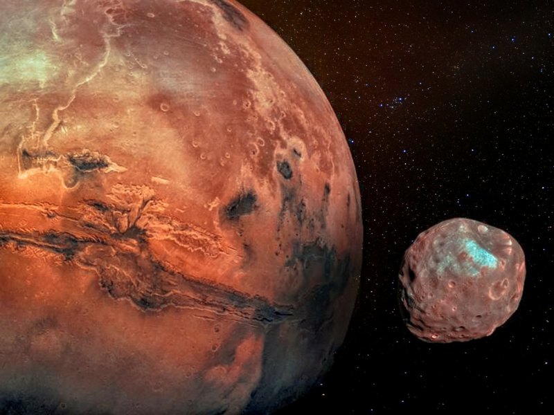 Der Planet Mars und seine zwei Monde Phobos und Deimos.