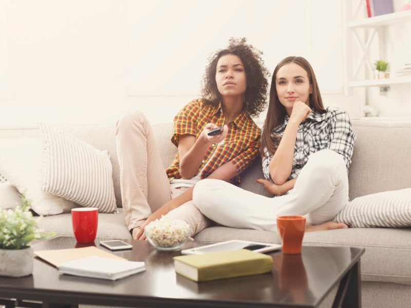 Zwei Freundinnen nachdenklich vor dem TV