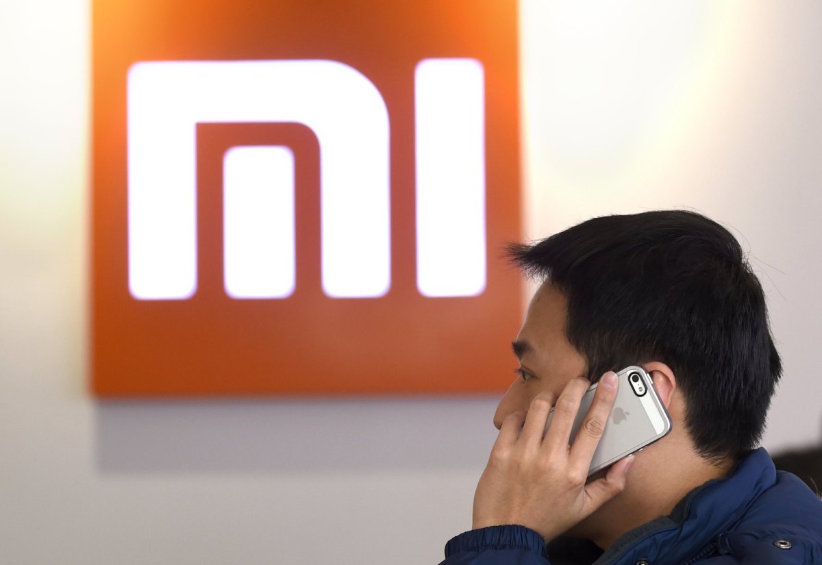 Mann telefoniert vor Xiaomi-Logo