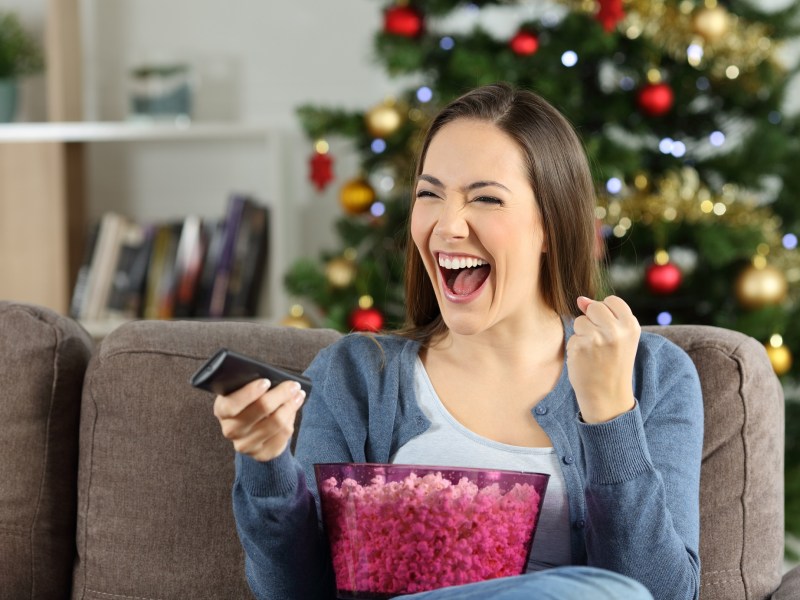 Frau an Weihnachten vor dem Fernseher