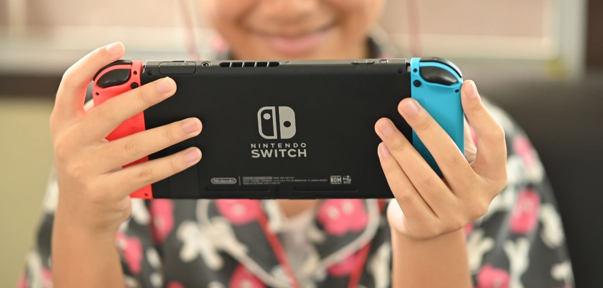 Person hält eine Nintendo Switch in Händen.