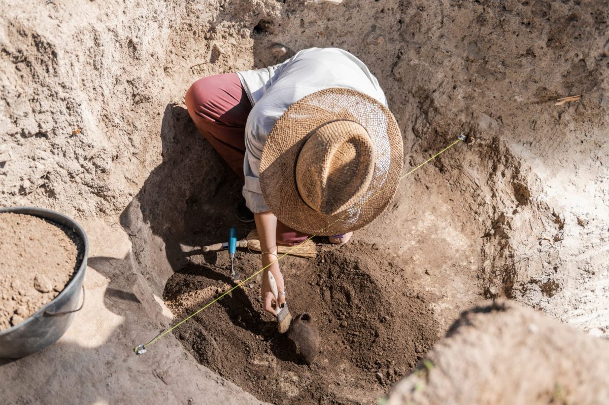 Mensch arbeitet an einem archäologischen Fund.