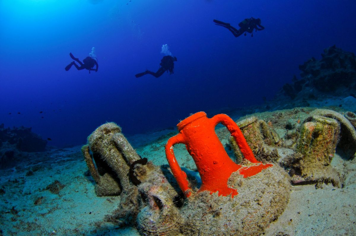 Taucher schwimmen auf einen archäologischen fund zu